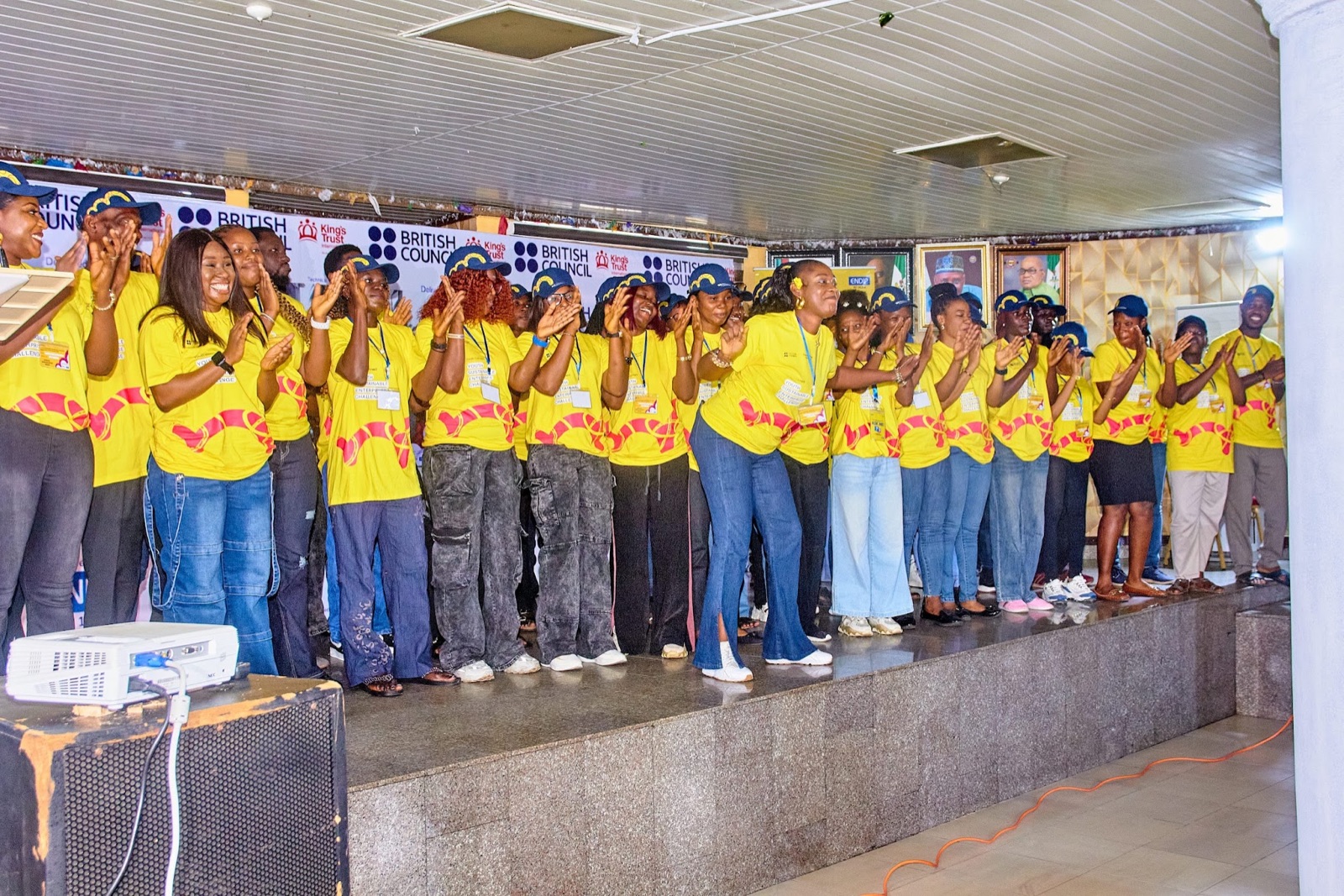 A large crowd in matching shirts applauding at an ENDIP event