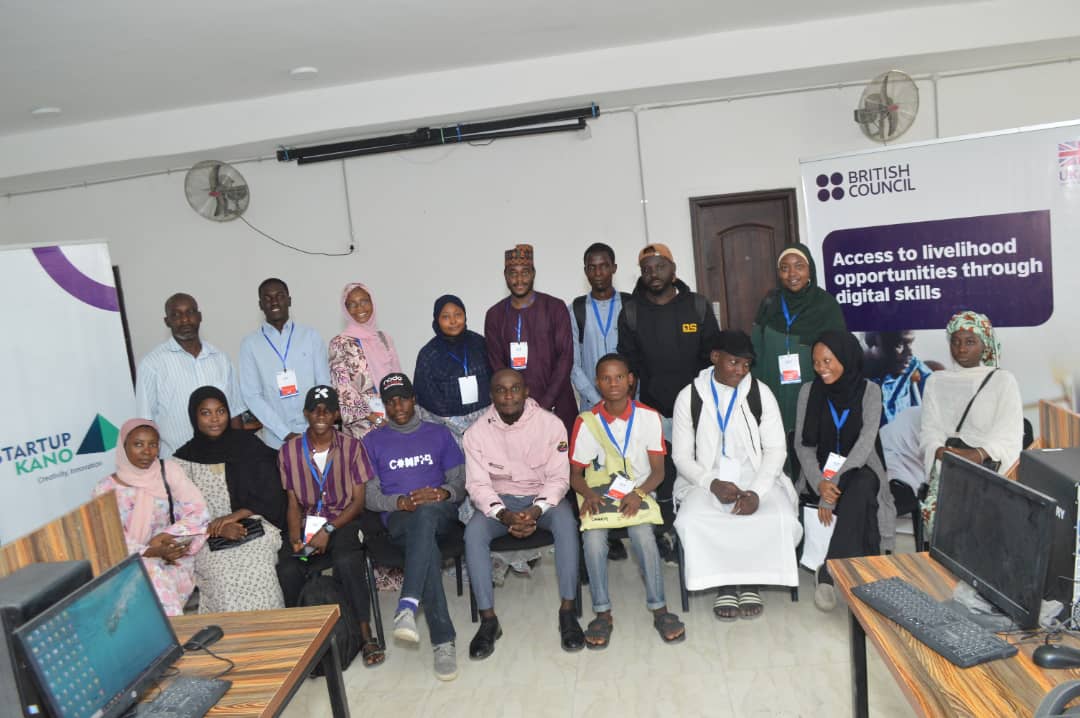 Digital skills participants posing with the British Council and Startup Kano banners in a training lab