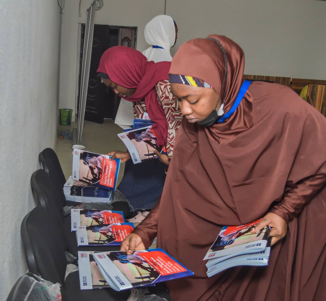 ENDIP staff packing branded digital skills and entrepreneurship training booklets